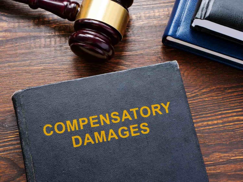 Compensatory Damages Available After a Texas Motorcycle Accident Law book labeled compensatory damages beside a judge’s gavel, representing financial compensation after a motorcycle accident in Texas
