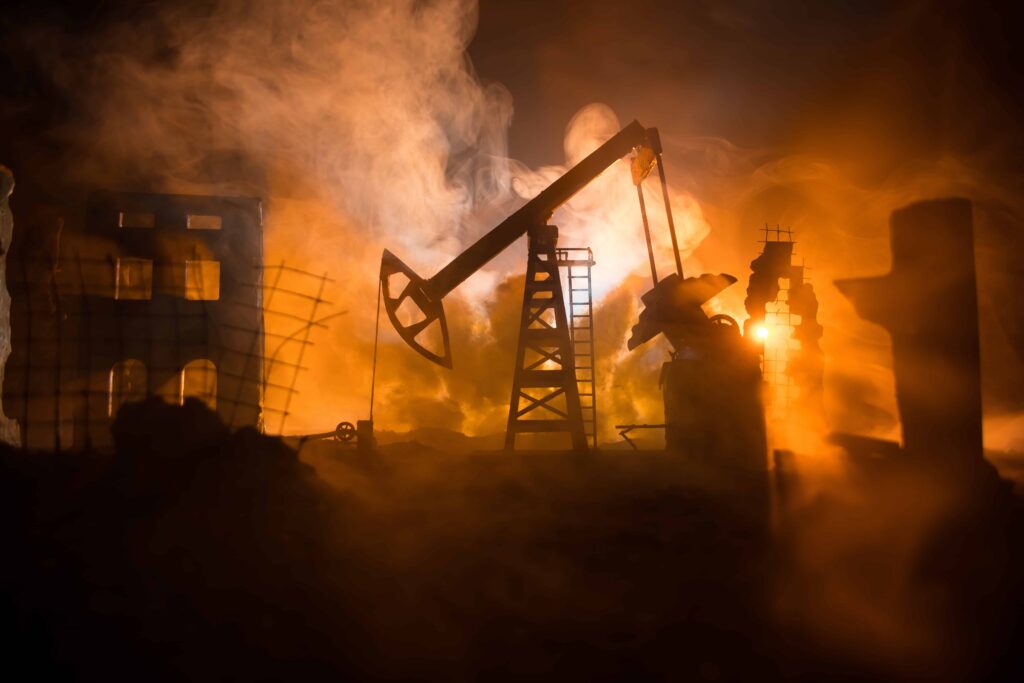 Oil pump jack operating amid fire and smoke at industrial site, depicting oil field accident, explosion risk, and energy industry hazards Oil pump jack operating amid fire and smoke at industrial site, depicting oil field accident, explosion risk, and energy industry hazards