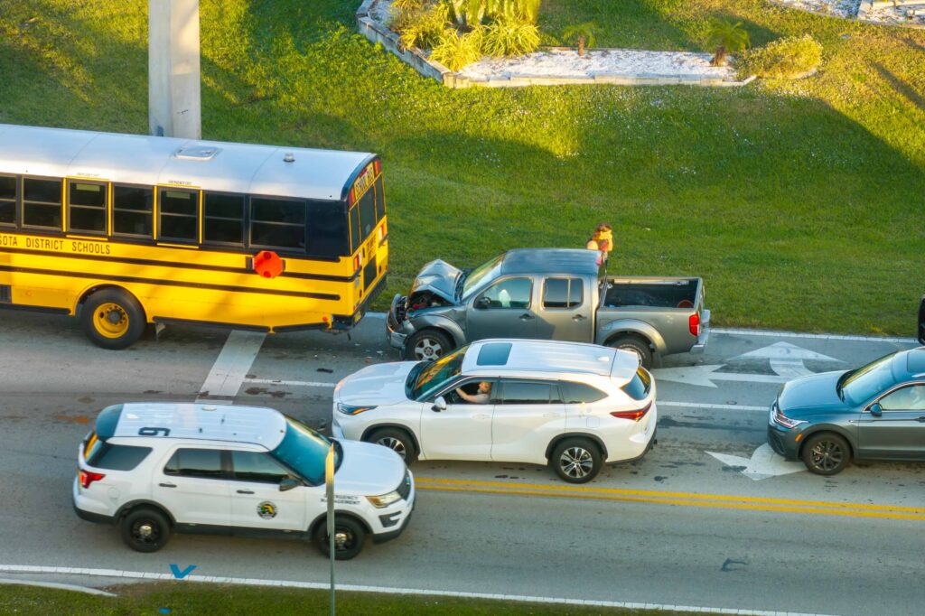 Aerial view of school bus and pickup truck collision with multiple vehicles involved, depicting a traffic accident near a school transportation route Aerial view of school bus and pickup truck collision with multiple vehicles involved, depicting a traffic accident near a school transportation route