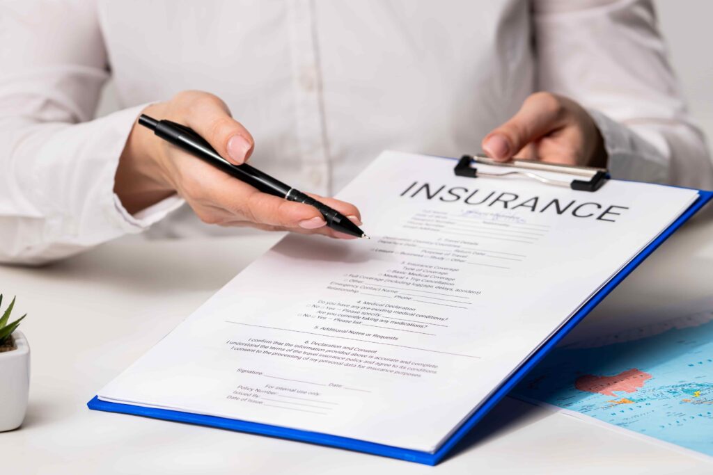 Person reviewing and signing an insurance policy on a clipboard, representing coverage selection, claims process, and financial protection planning Person reviewing and signing an insurance policy on a clipboard, representing coverage selection, claims process, and financial protection planning