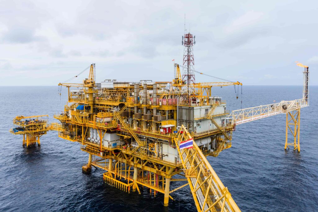 Offshore oil platform in the ocean with industrial equipment and pipelines, representing energy production, drilling operations, and oil and gas industry infrastructure