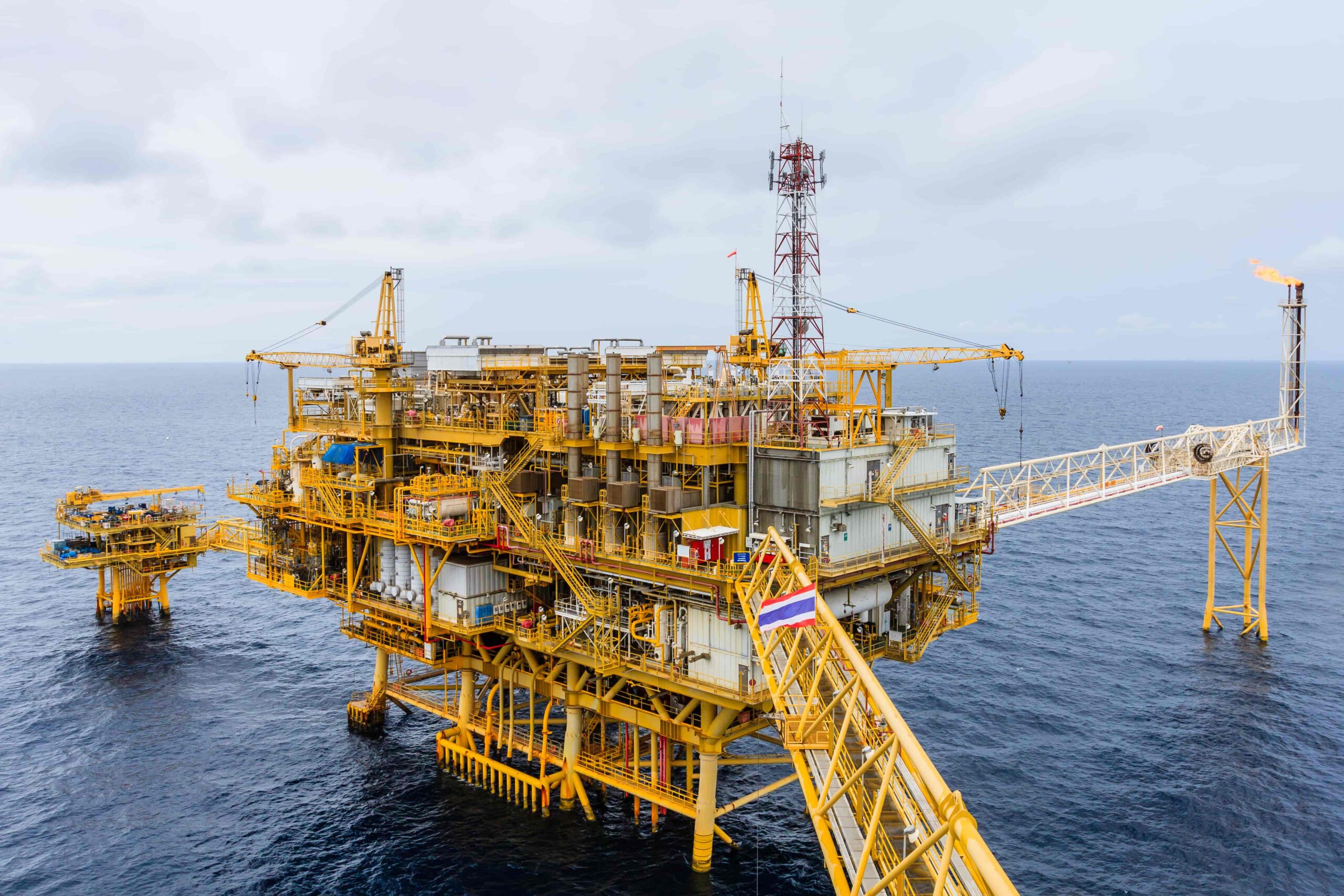 Offshore oil platform in the ocean with industrial equipment and pipelines, representing energy production, drilling operations, and oil and gas industry infrastructure