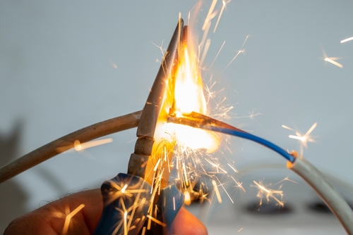 Electric wires sparking during a dangerous electrical incident, illustrating risks handled by a Houston electrocution accident lawyer.