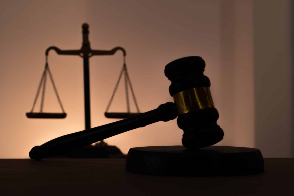 Judge&rsquo;s gavel and scales of justice in silhouette, symbolizing legal decisions, court proceedings, and justice system concept