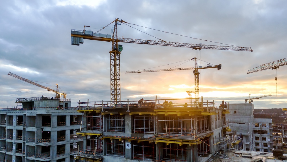 crepuscular view of construction site with cranes