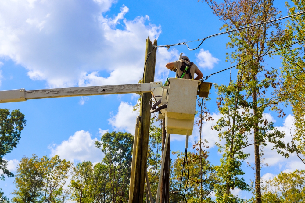 lineman repairing power line from cherry picker