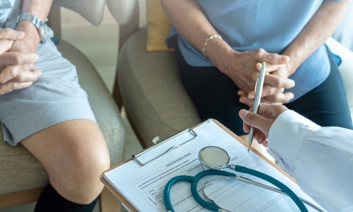 Close-up of family speaking to doctor during medical consultation