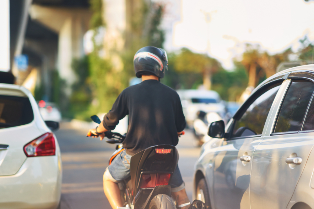 motorcycle driver splitting a lane