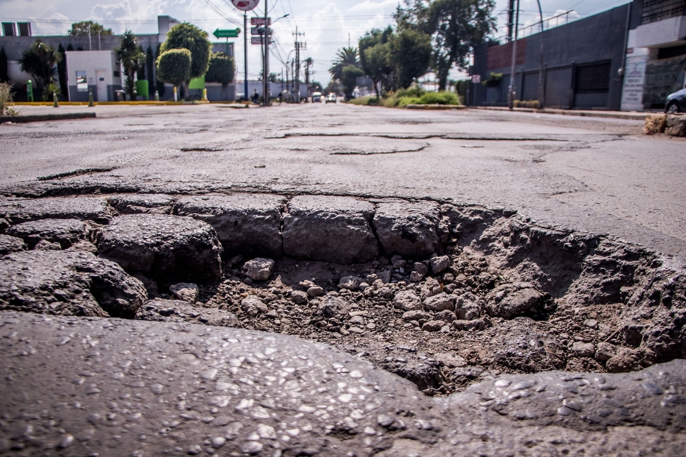 deep pothole, potential road accident cause
