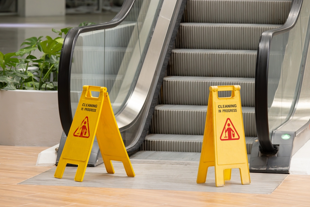 Caution standees at the foot of an escalator