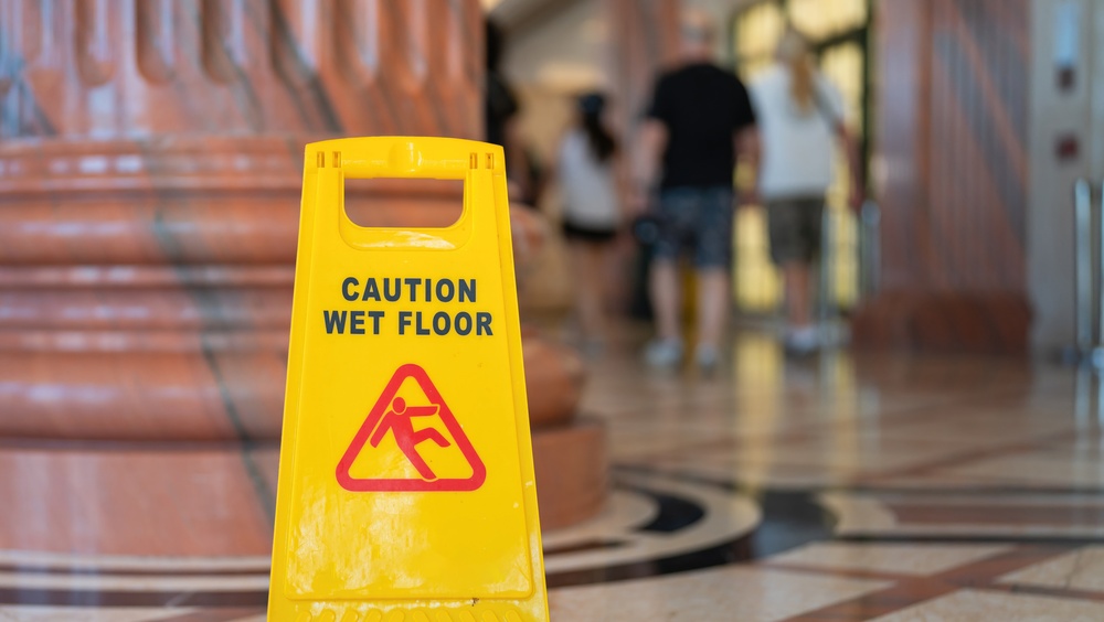 Wet floor sign in atrium of government building