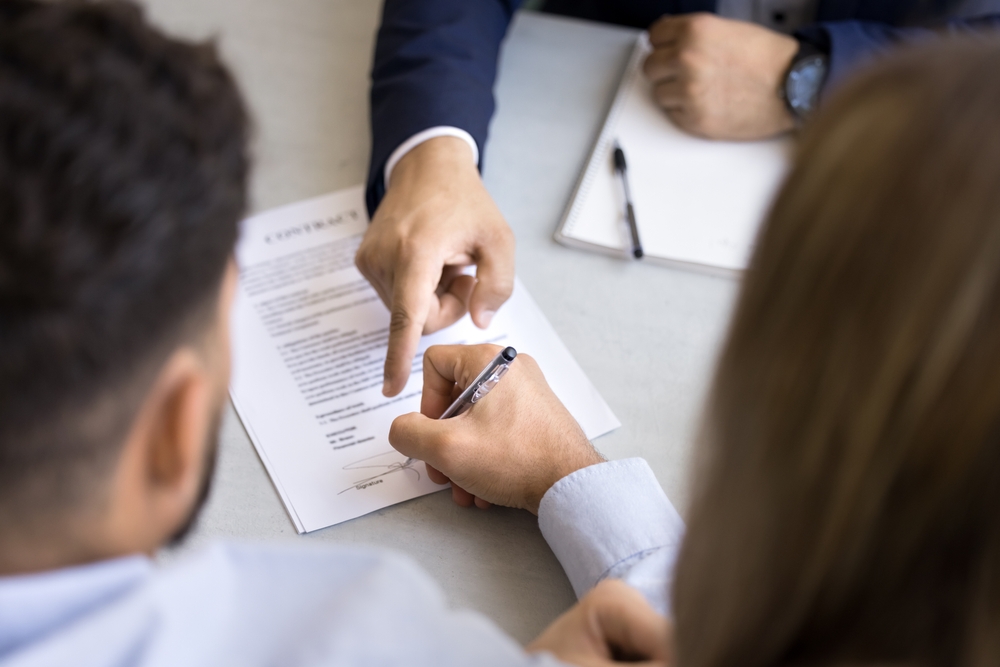 Close-up of legal counsel having argument with clients, a red flag in hiring a law firm